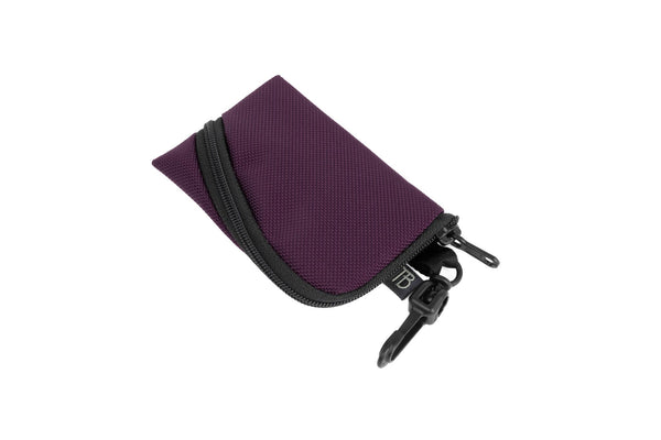 A Super Mini Ghost Whale Pouch in Aubergine (dark purple).